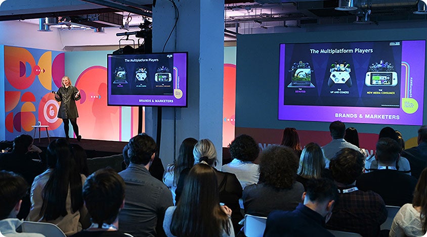 Audience watching a presentation about multiplatform players at Advertising Week Europe 2024.