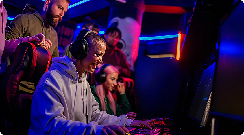 A row of PC players with a crowd behind them watching gameplay