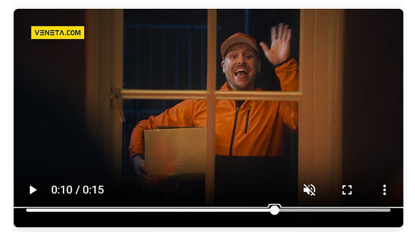 Delivery person waving at window at night