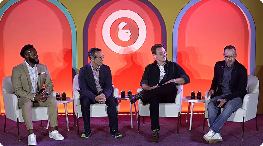 Four panelists seated onstage in chairs, speaking at Advertising Week New York 2024 and audience seating in front.