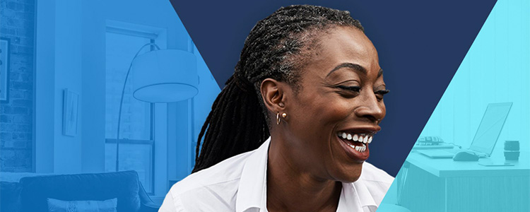 A woman smiles while looking away from the camera.