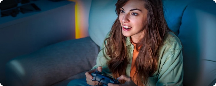 Woman engaged in playing a video game with a controller at home