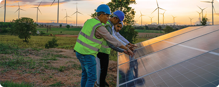 Three male engineers investigating a solar panel.